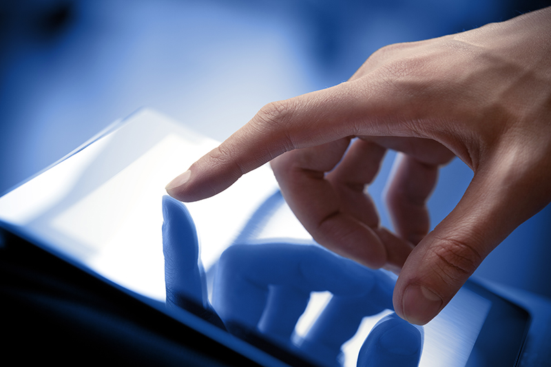 Fractional Chief Information Officer touching a tablet screen
