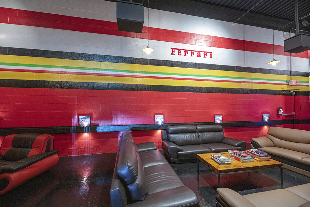 Inside EMCO Technology Lounge. Ferrari logo and colors on wall.